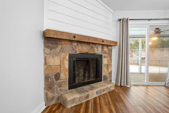 details with hardwood / wood-style flooring and a fireplace