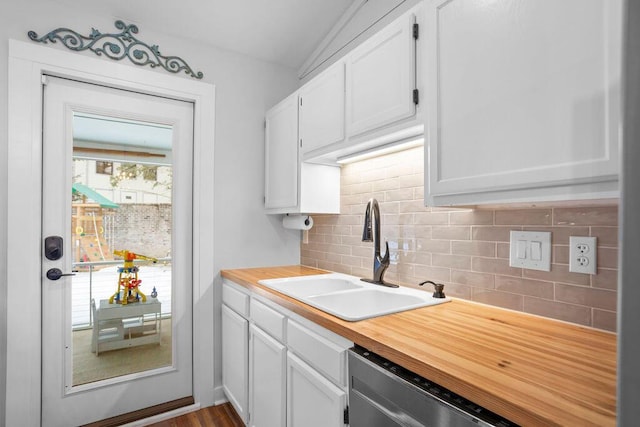 kitchen featuring stainless steel dishwasher, sink, decorative backsplash, and white cabinets