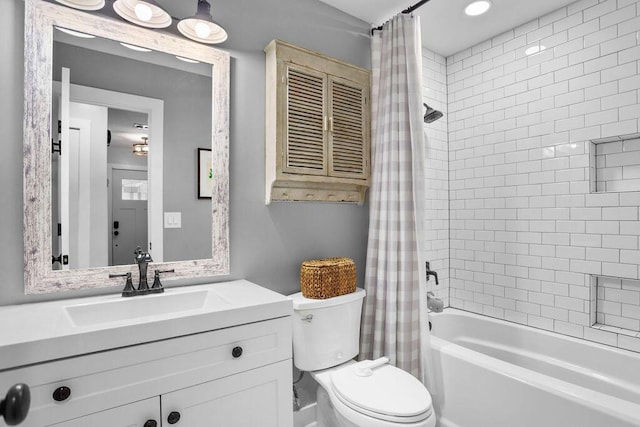 full bathroom with shower / tub combo, vanity, and toilet