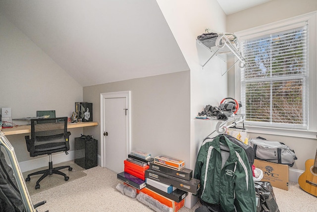 carpeted office space with lofted ceiling