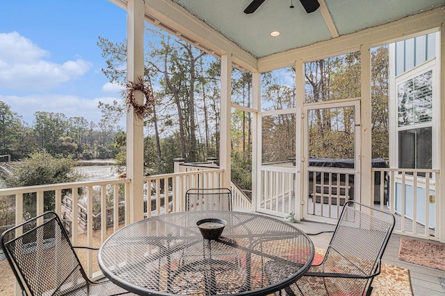 sunroom / solarium with a wealth of natural light and ceiling fan