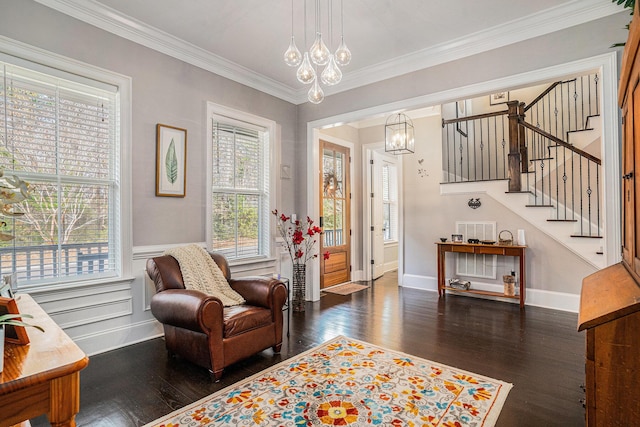 living area featuring ornamental molding and dark hardwood / wood-style floors