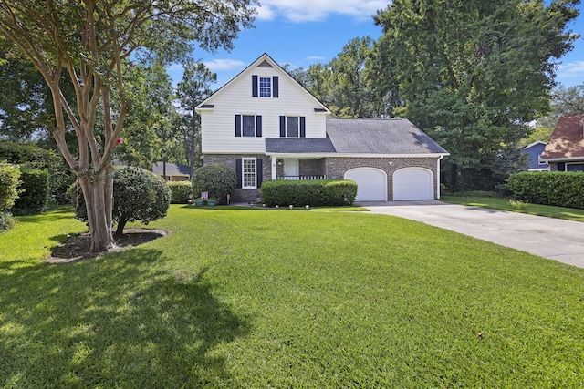 traditional-style home featuring brick siding, a front yard, a garage, and concrete driveway