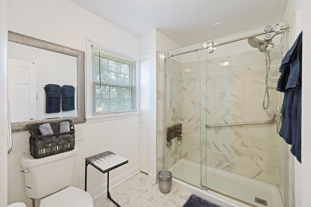 bathroom with toilet and a stall shower
