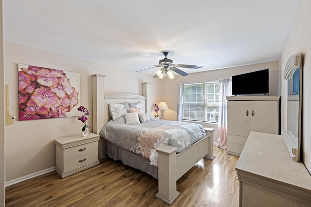 bedroom featuring baseboards, a ceiling fan, and wood finished floors