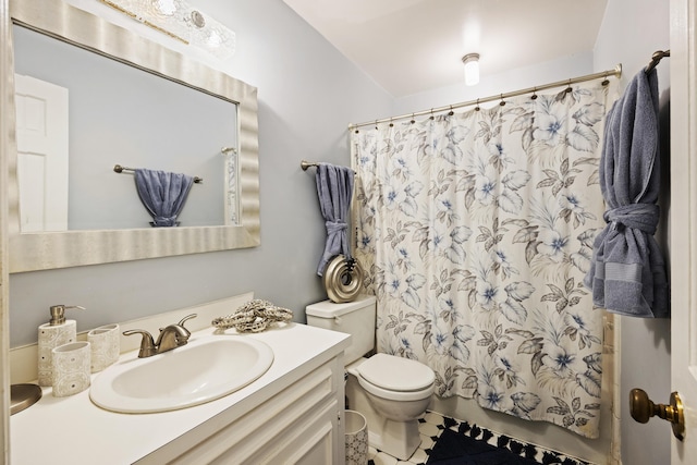 bathroom featuring shower / bathtub combination with curtain, vanity, and toilet