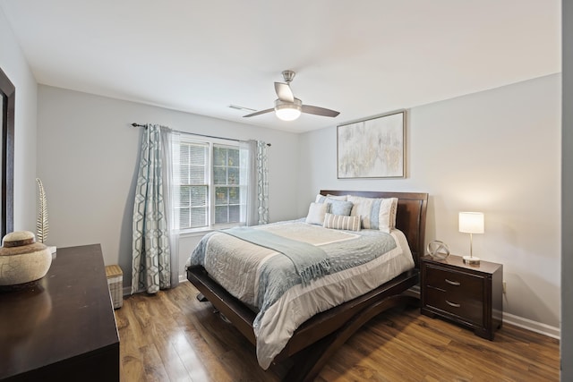 bedroom with baseboards, a ceiling fan, and wood finished floors