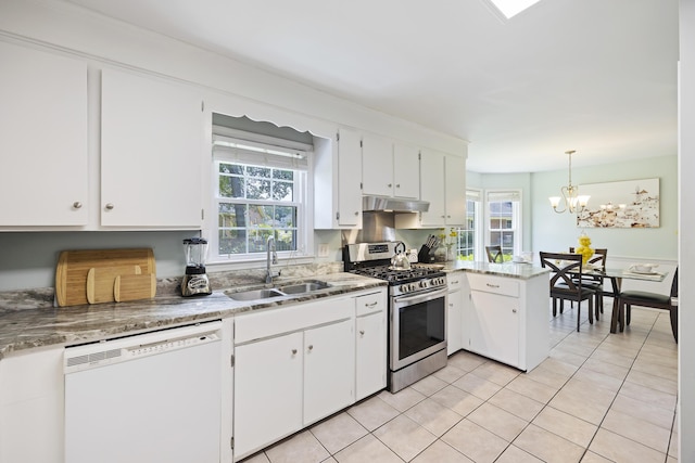 kitchen featuring a peninsula, under cabinet range hood, stainless steel gas range, a sink, and white dishwasher