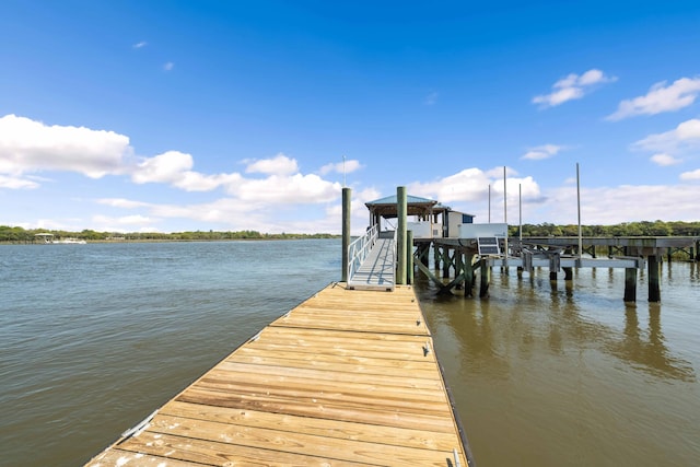 dock area with a water view and boat lift