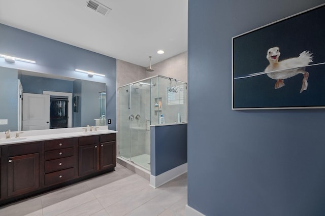 bathroom with vanity, tile patterned flooring, and an enclosed shower