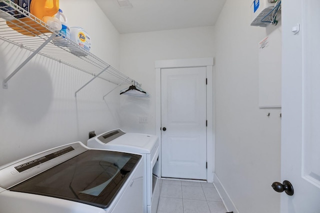 washroom with washing machine and clothes dryer and light tile patterned flooring