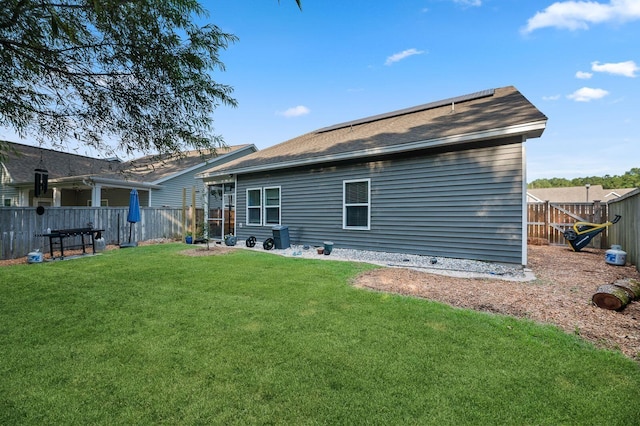 rear view of property with a lawn