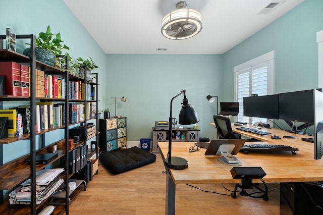 office space featuring light hardwood / wood-style flooring and ceiling fan