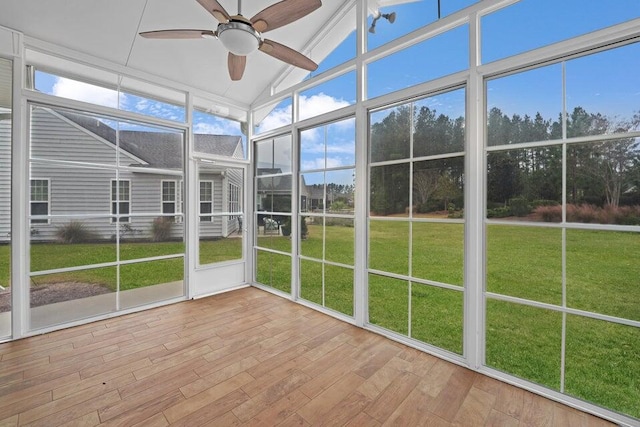 unfurnished sunroom featuring ceiling fan and vaulted ceiling