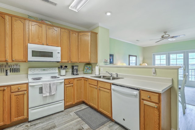 2393 Folly Rd Unit 1G, Folly Beach, SC 29439 - kitchen featuring white appliances, a peninsula, a sink, light wood-type flooring, and crown molding