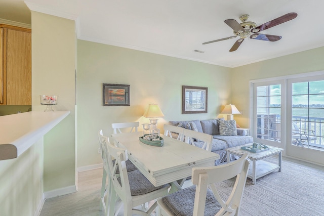 2393 Folly Rd Unit 1G, Folly Beach, SC 29439 - dining area with light wood-style floors, baseboards, a ceiling fan, and crown molding