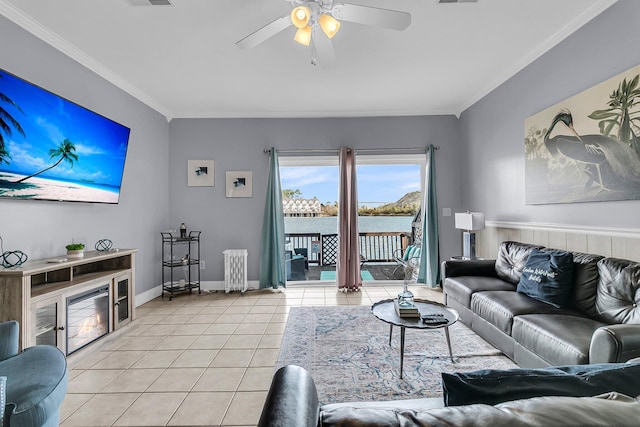 living area featuring ceiling fan, ornamental molding, light tile patterned flooring, and visible vents