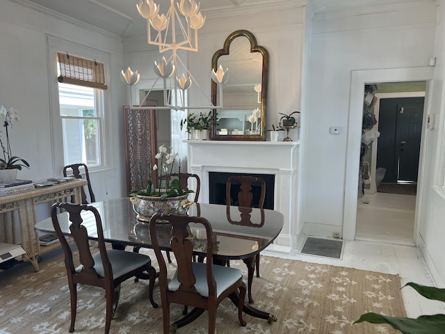 dining area with an inviting chandelier and ornamental molding