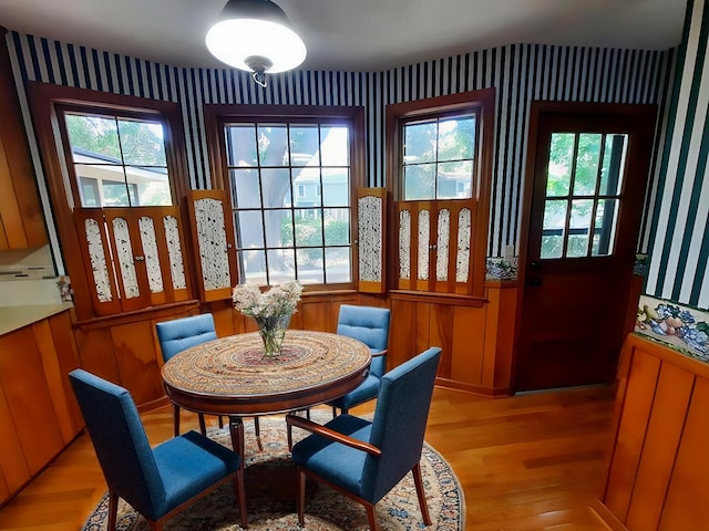 dining space with a wealth of natural light and light wood finished floors