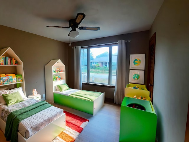 bedroom with light wood-style floors and ceiling fan