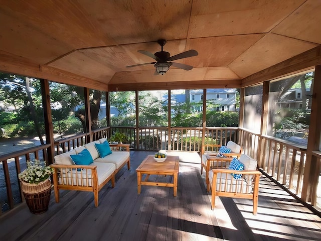 sunroom featuring wooden ceiling, a ceiling fan, and vaulted ceiling