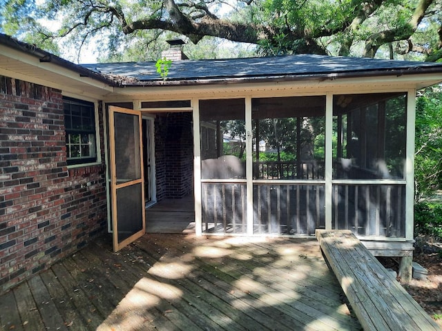 wooden deck with a sunroom