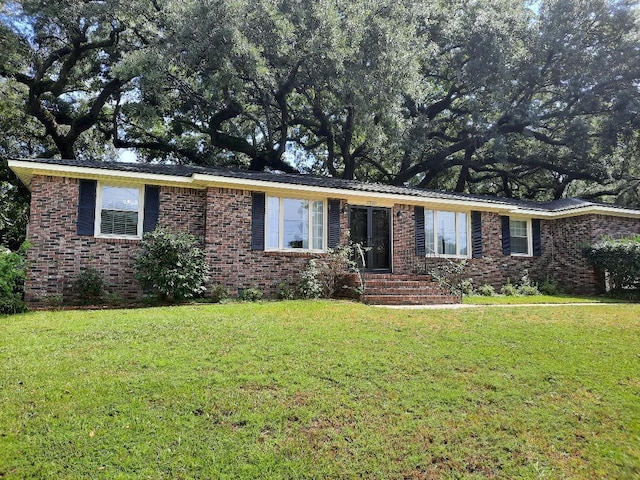 single story home with a front lawn and brick siding