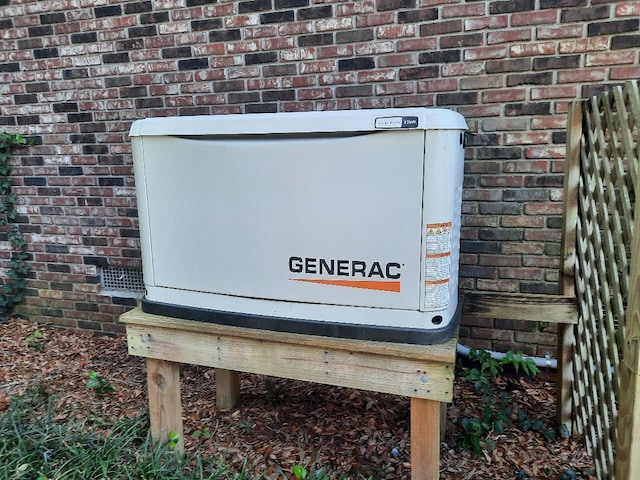 exterior details featuring brick siding and a power unit