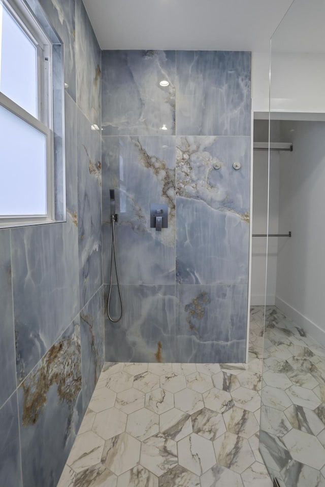 bathroom with walk in shower and a wealth of natural light