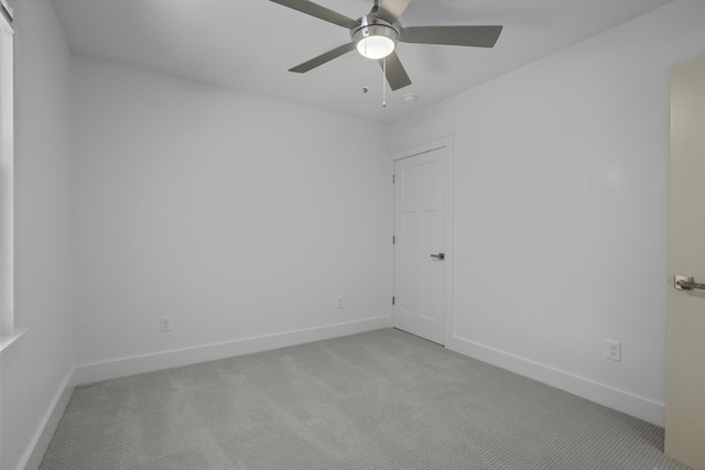 empty room featuring light carpet and ceiling fan