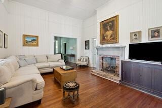 living room featuring a fireplace and dark hardwood / wood-style floors