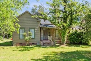 back of house with a lawn