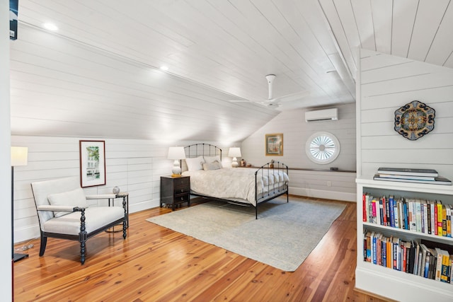 bedroom with ceiling fan, wooden ceiling, hardwood / wood-style floors, and wood walls