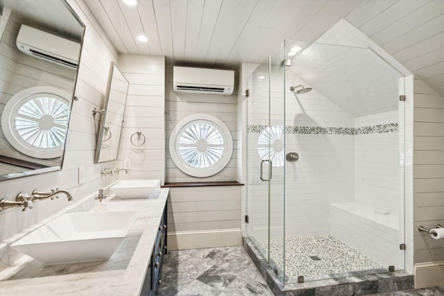 bathroom featuring an enclosed shower, vanity, and an AC wall unit