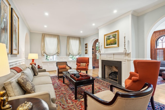 living room featuring crown molding and light hardwood / wood-style flooring