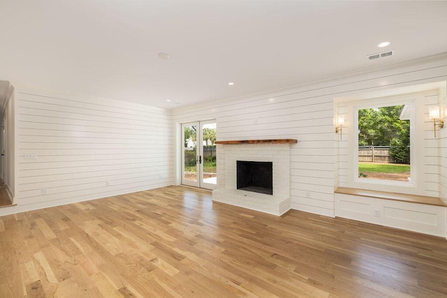 1199 Island View Dr, Mount Pleasant, SC 29464 - unfurnished living room with a fireplace, visible vents, plenty of natural light, and light wood-style floors
