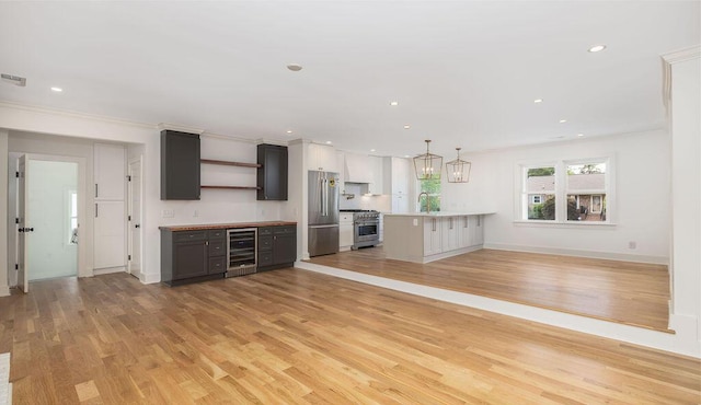 1199 Island View Dr, Mount Pleasant, SC 29464 - kitchen featuring open shelves, light wood-type flooring, light countertops, beverage cooler, and high end appliances