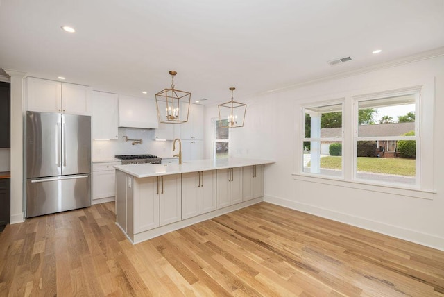 1199 Island View Dr, Mount Pleasant, SC 29464 - kitchen featuring an inviting chandelier, freestanding refrigerator, visible vents, light countertops, and tasteful backsplash
