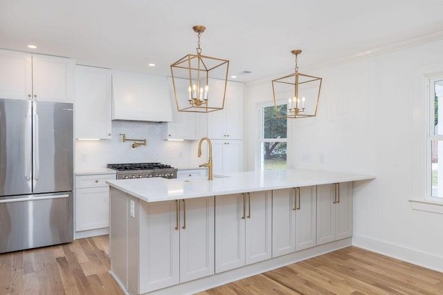 1199 Island View Dr, Mount Pleasant, SC 29464 - kitchen featuring a sink, exhaust hood, freestanding refrigerator, light wood finished floors, and a notable chandelier
