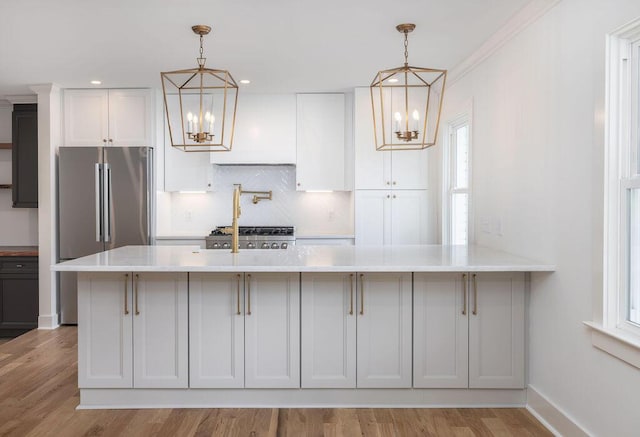 1199 Island View Dr, Mount Pleasant, SC 29464 - kitchen with freestanding refrigerator, an inviting chandelier, light countertops, and tasteful backsplash