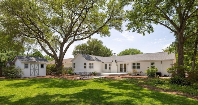 1199 Island View Dr, Mount Pleasant, SC 29464 - back of house with a patio area, an outdoor structure, french doors, a shed, and a lawn