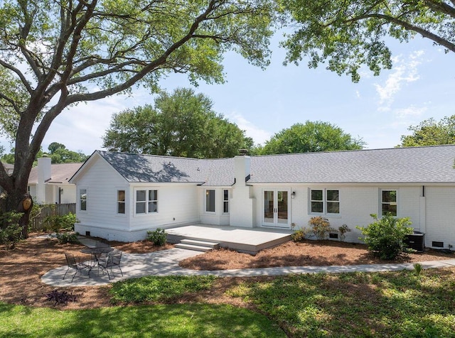 1199 Island View Dr, Mount Pleasant, SC 29464 - back of house featuring a chimney, brick siding, french doors, a patio area, and a shingled roof