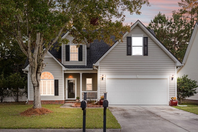 view of front of house featuring a lawn and a garage