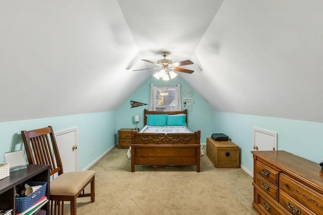 carpeted bedroom with ceiling fan and vaulted ceiling