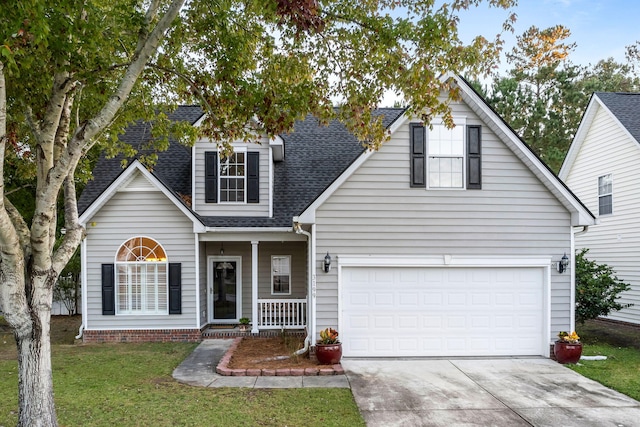 view of front of house featuring a front lawn, a porch, and a garage