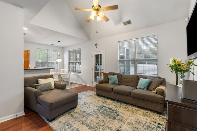 living room featuring ceiling fan, dark wood-type flooring, and vaulted ceiling