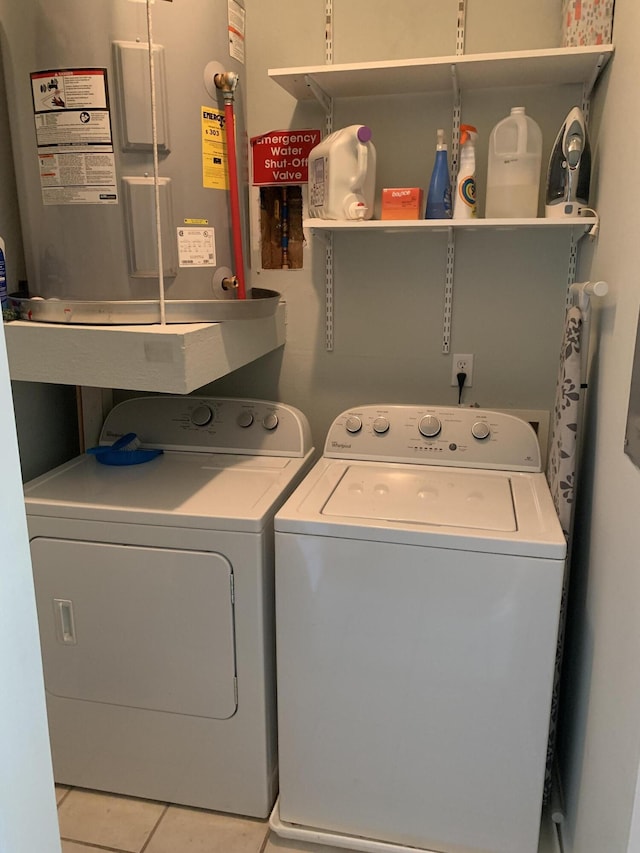 washroom featuring tile patterned floors, washing machine and dryer, and laundry area
