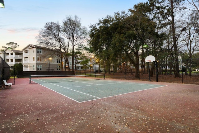 view of tennis court featuring fence