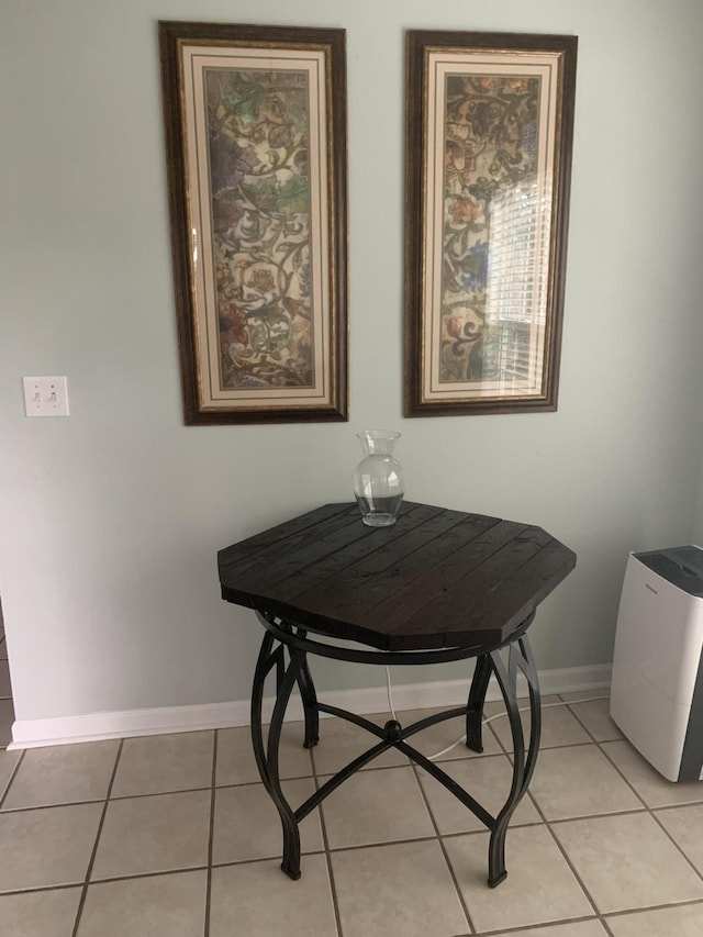dining space with light tile patterned floors and baseboards