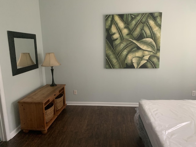bedroom featuring wood finished floors and baseboards